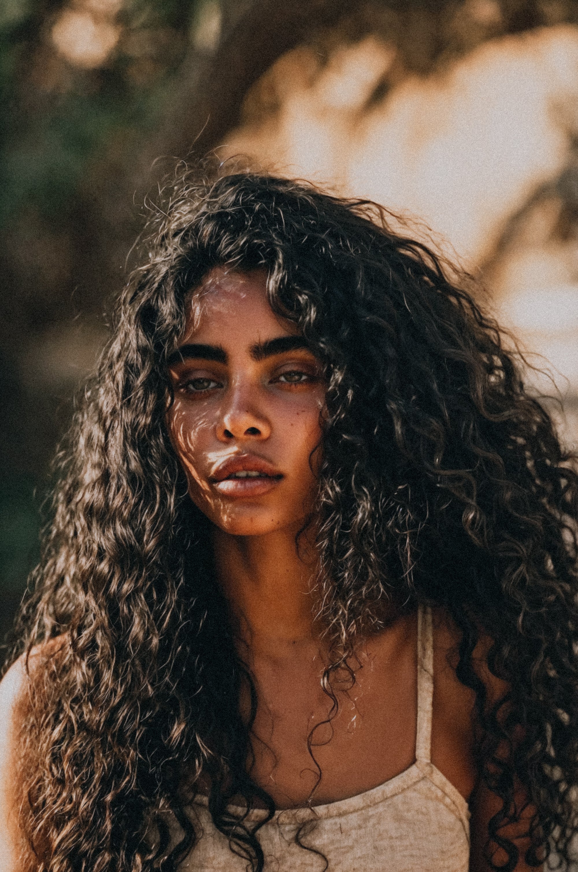 woman with long curly hair and beautiful skin